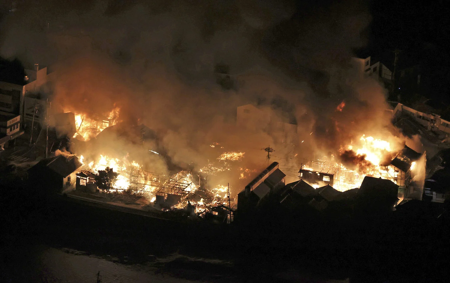 An aerial image taken on January 1, 2024, in Wajima City, Ishikawa Prefecture, depicts a fire caused by a strong earthquake. (The Yomiuri Shimbun / Takehito Kobayashi via AP)