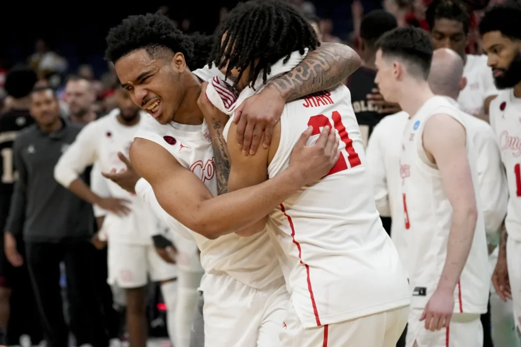 Houston guard Ramon Walker Jr, left, and Houston guard Emanuel sharp (21) celebrate the team's win after a second-round college basketball game against Texas A&M in the NCAA Tournament, SUnday, March 24,2024, in Memphis, Tenn. Houston won 100-95 in overtime.