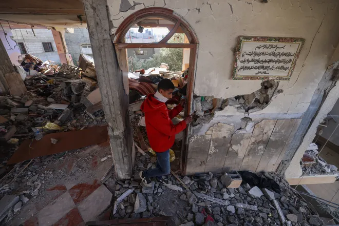 A Palestinian youth inspects a damaged department apartment following overnight Israeli bombardment in Rafah in the southern Gaza strip on April 4, 2024.